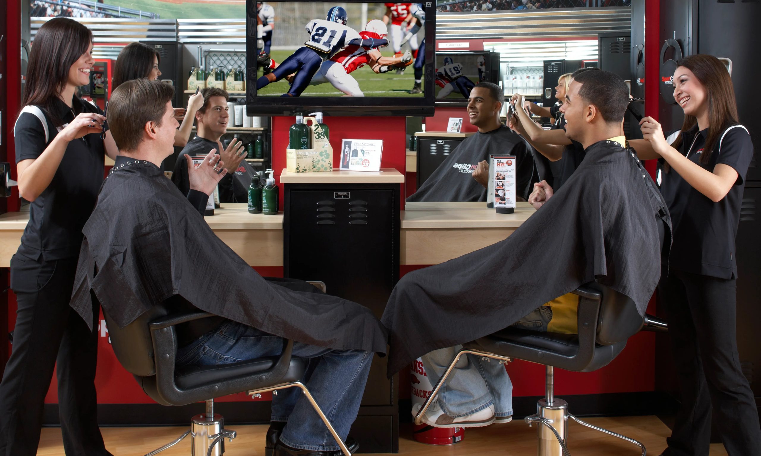 Interior of a Sports Clips salon with modern barber chairs and sports-themed decor.