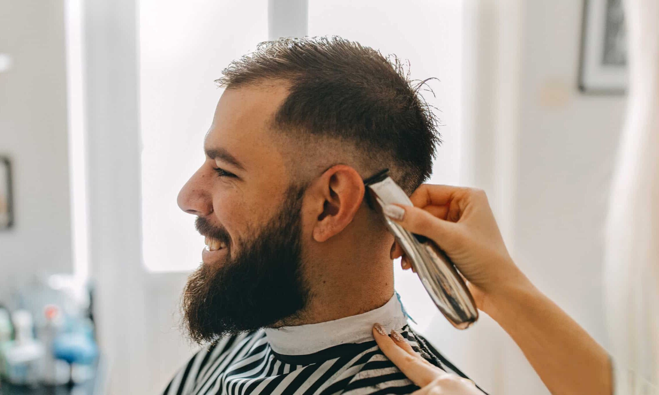 Barber giving a client a V shape hairstyle