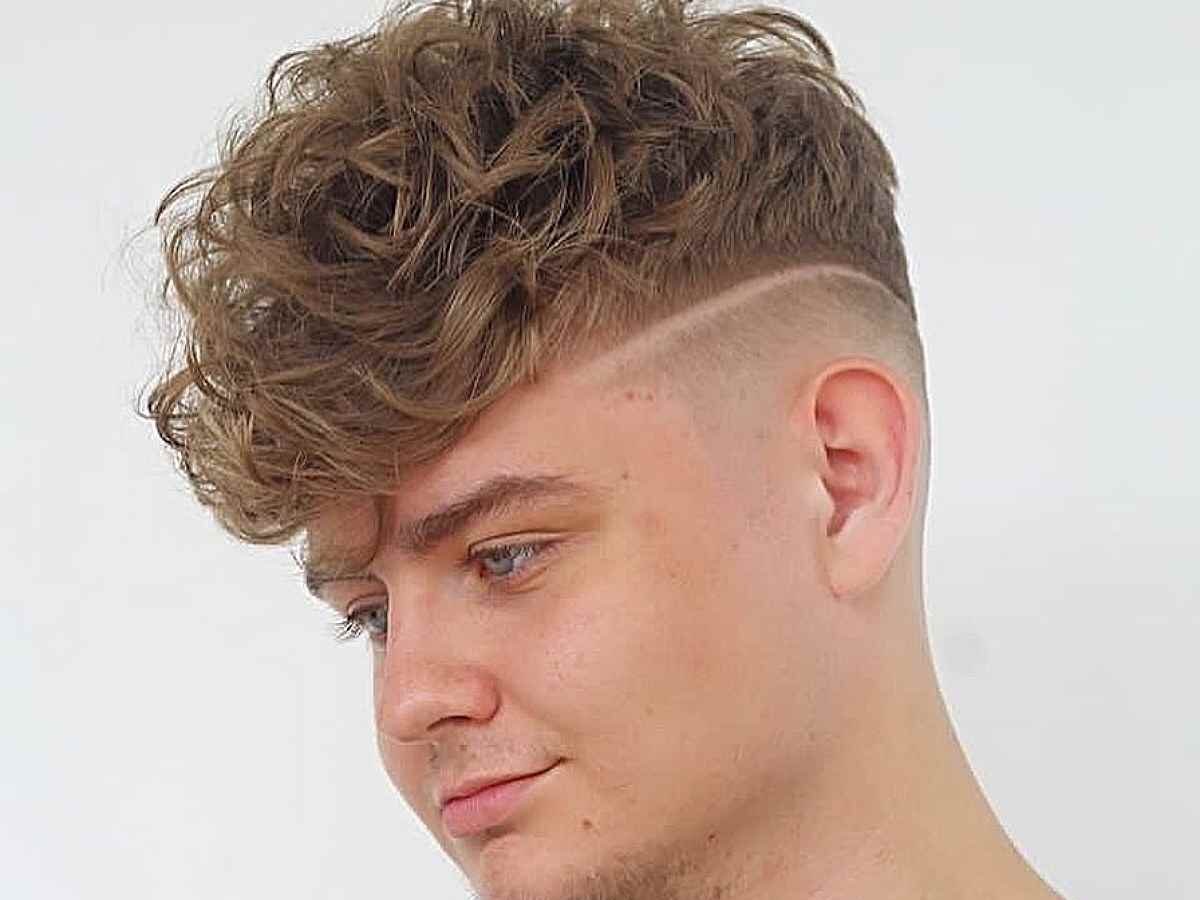 Close-up of intricate side line haircut on curly hair
